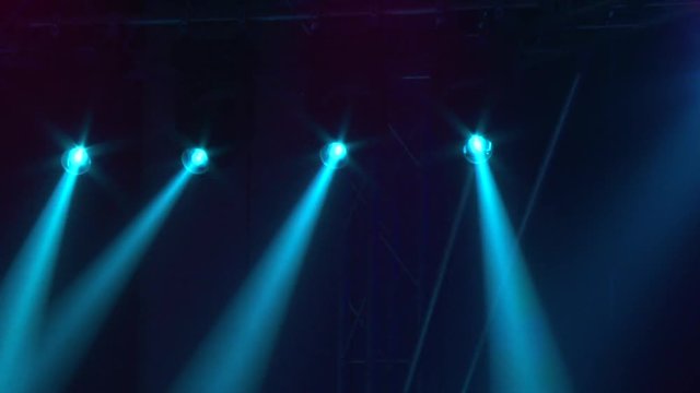 Light at the concert. Stroboscopes shine, colorful light.
