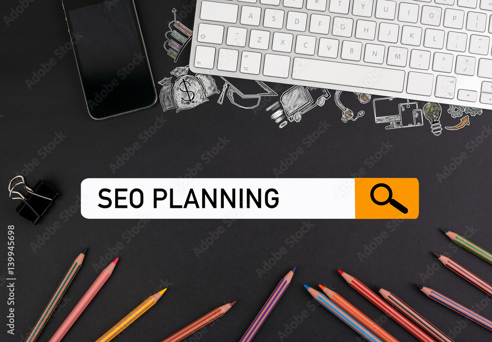 Wall mural seo search engine optimization concept. colorful pencils and a computer keyboard with a mobile phone