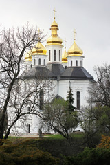 Fototapeta na wymiar Church in the trees. Church. Old Church in Chernigov. Golden dome. History. Old City