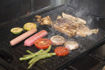 Grilled pork with sausage, mixed grilled vegetables. Aji sauce (chili).