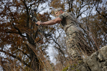 Bow hunter on a hill