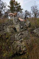 Bow hunter on a hill
