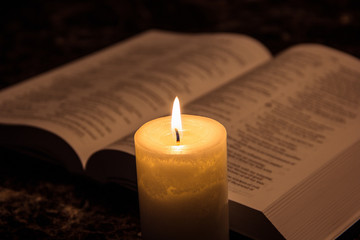 Candle & the bible in the dark