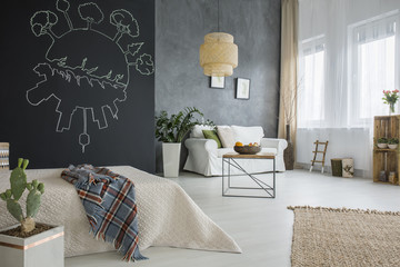 Apartment with chalkboard and bed