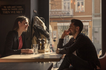 young woman man silhouette sitting caffe shop window