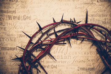 Crown of thorns with Jesus names and attributes in the background. - 139951084