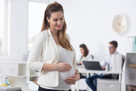 Pregnant woman in bright office