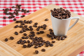 Coffee cup and beans on a rustic table