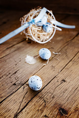 Easter basket with colored easter eggs  on old rustic wooden table.free text space. Selective focus.