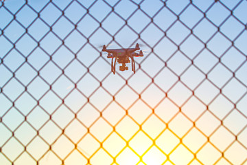 Drone flying over fence