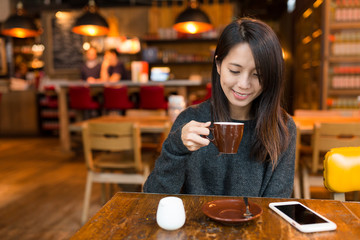 Woman enjoy her coffee in restaurant