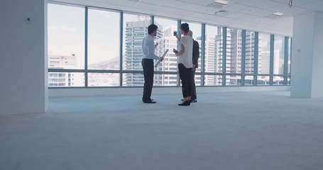 Businesspeople discussing interior plan with architect in an emplty office space. Architect meeting with clients and discussing future interior of unfurnished building.
- Powered by Adobe