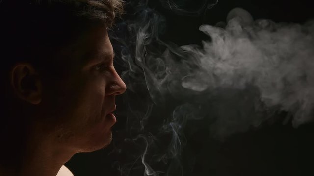 SLOW MOTION: Smoker in a smog