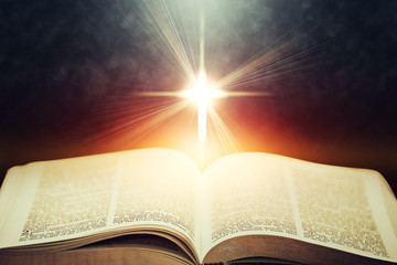 Light flares illuminating the Holy Bible - obrazy, fototapety, plakaty