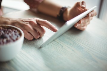 Hand of woman using digital tablet