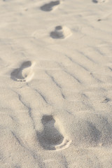 Fußspuren in weißem Sand