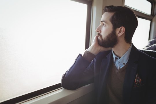 Businessman looking out through train window
