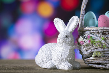 Easter rabbit with eggs. colorful bokeh. place for typography