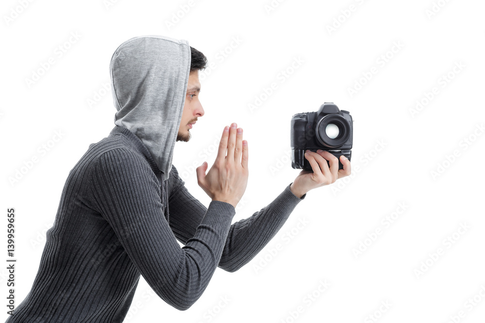 Wall mural young professional photographer prays for dslr digital camera is