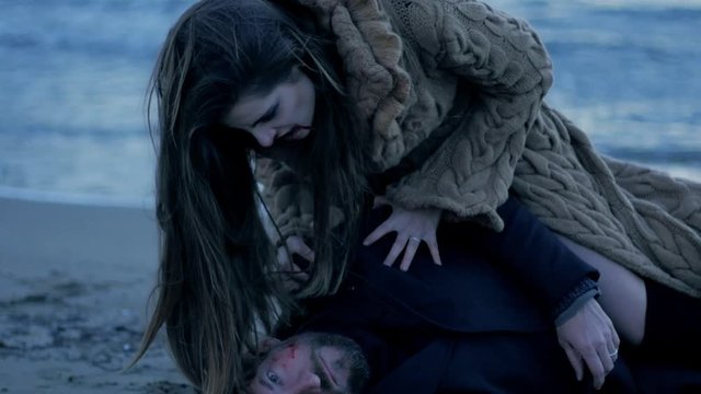Female vampire eating dead man