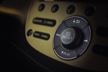 Close up dashboard of a volume control music and radio in car with selective focus.
