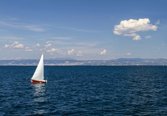 Sailboat in clear sunny weather on the calm seas. Mediterranean sea.