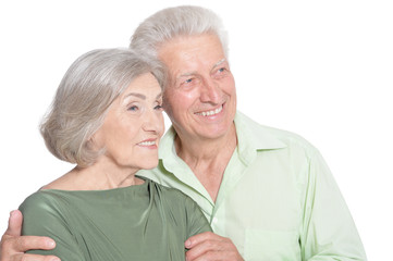 Happy old couple embracing on a white background