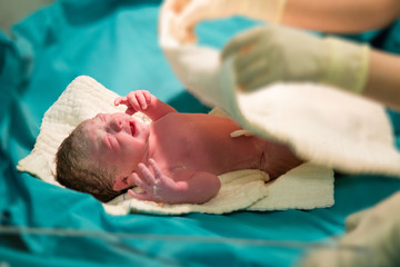 Brand New Baby.Newborn baby girl getting checked by the doctor 