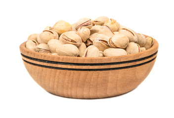 Big wooden bowl with pistachio nuts on a white background