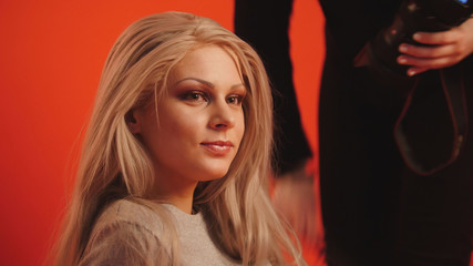 Naklejka premium Small business - Young blonde female model posing for photographer - fashion backstage