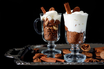 Sweet dessert with chocolate, cocoa, nuts and whipped cream