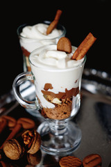Sweet dessert with chocolate, cocoa, nuts and whipped cream