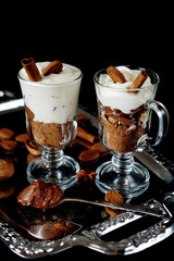Sweet dessert with chocolate, cocoa, nuts and whipped cream