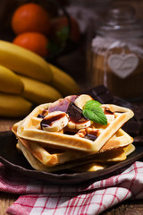 Delicious waffles with banana and chocolate