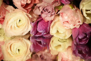 Beautiful white roses and pink, white tulipson the shiny surface of the sparkling drops. a beautiful reflection surface. 
