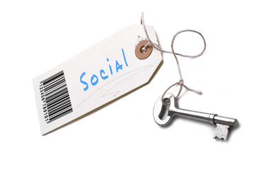 A silver key with a tag attached with a Social concept written on it.