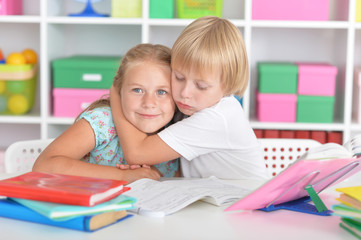 Fototapeta premium Girl and boy doing lessons