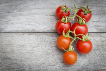 Closeup cherry tomato over vintage wooden background