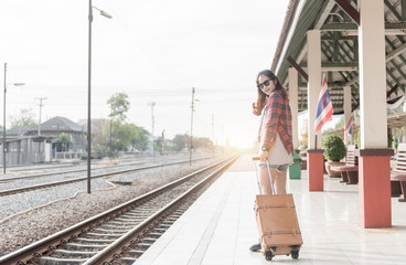 Hipster woman pull brown leather vintage bag at railway station.