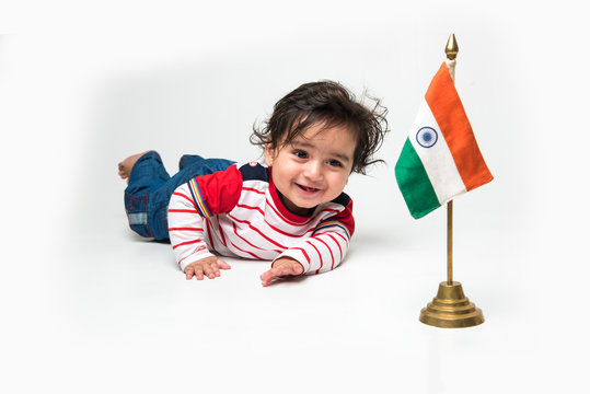 Cute baby boy on white background with indian flag or tricolour