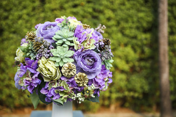 Beautiful flower arrangement over blurred green garden background