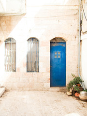 Fototapeta na wymiar Blue Door in White Stone Building