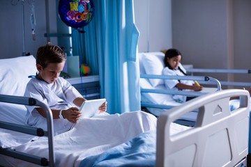 Patients with digital tablet and book sitting on bed - Powered by Adobe