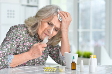 Elderly woman doing inhalation