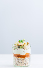 Oatmeal with fruit and cereals in a glass jar