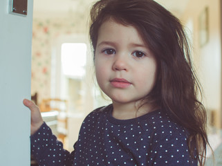Beautiful toddler girl with long hair looking