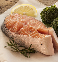 salmon raw. salmon red fish steak with herbs and lemon isolated on a white background