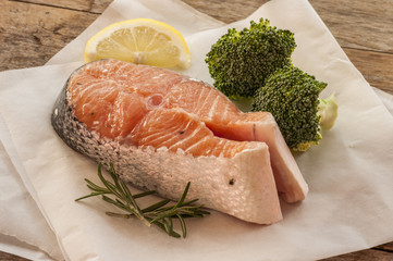 salmon raw. salmon red fish steak with herbs and lemon isolated on a white background
