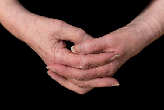 Close up of a female pensioner's hands loosely clasped