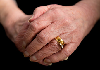 Close up of an elderly married lady's hands.